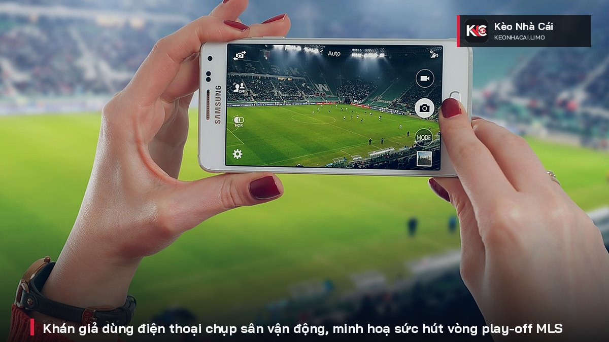 Spectators use their phones to photograph the stadium, illustrating the appeal of the MLS playoffs.